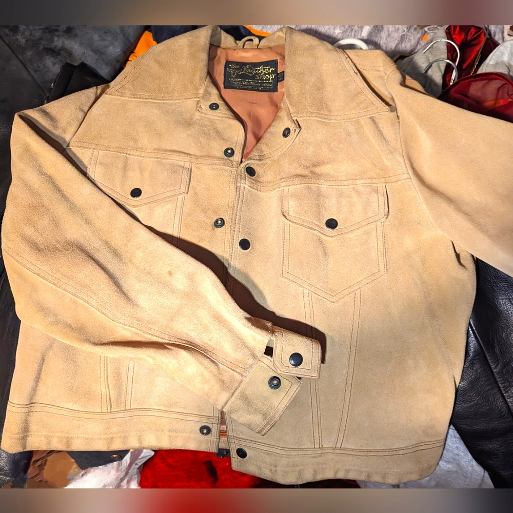 Tan genuine leather jacket. It's in excellent condition. Size 40 regular.